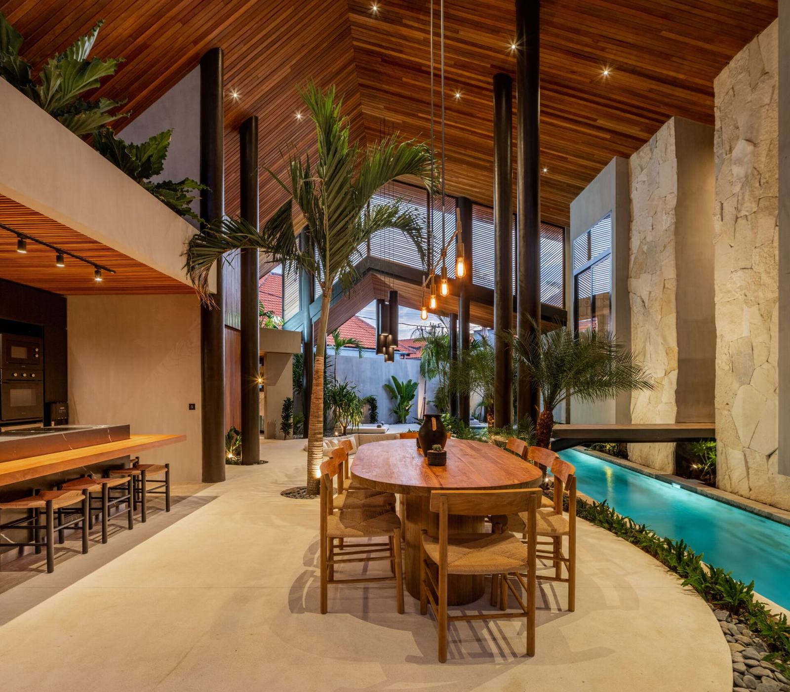 Long dining table set beside a 25-metre lap pool
