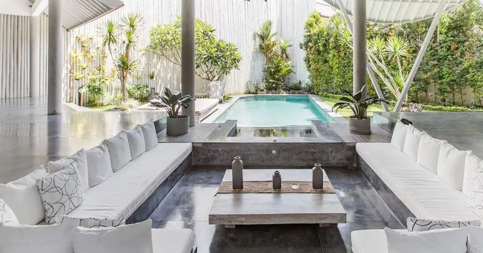 A sunken lounge beside the estate pool at dusk