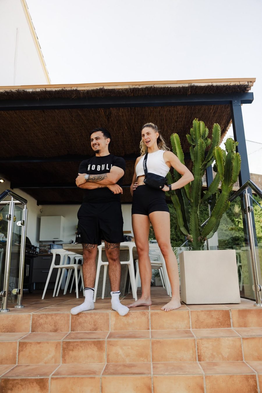 Beth and Danny together on the steps of a villa terrace