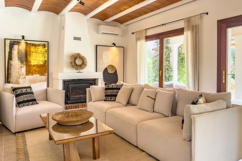 The living room with white sofas and a fireplace