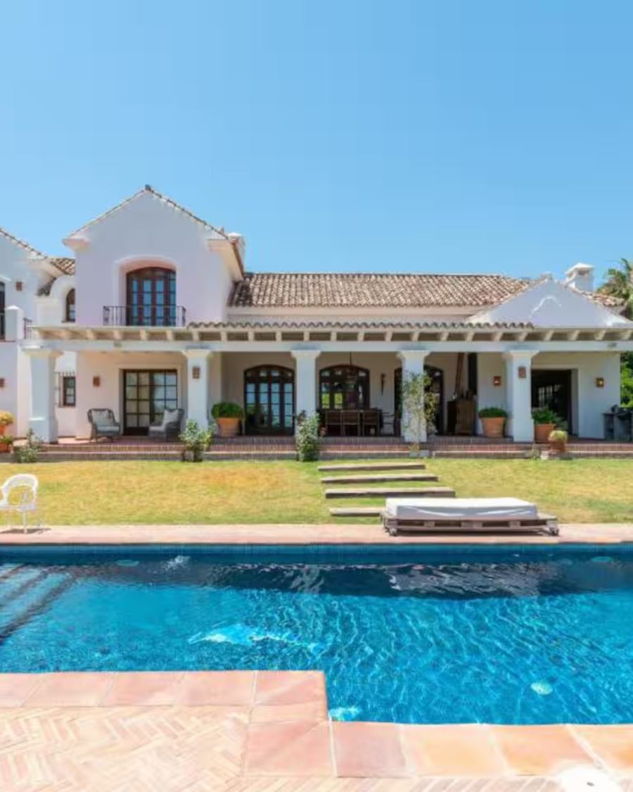 White estate villa with pool and lawns in the Marbella hills