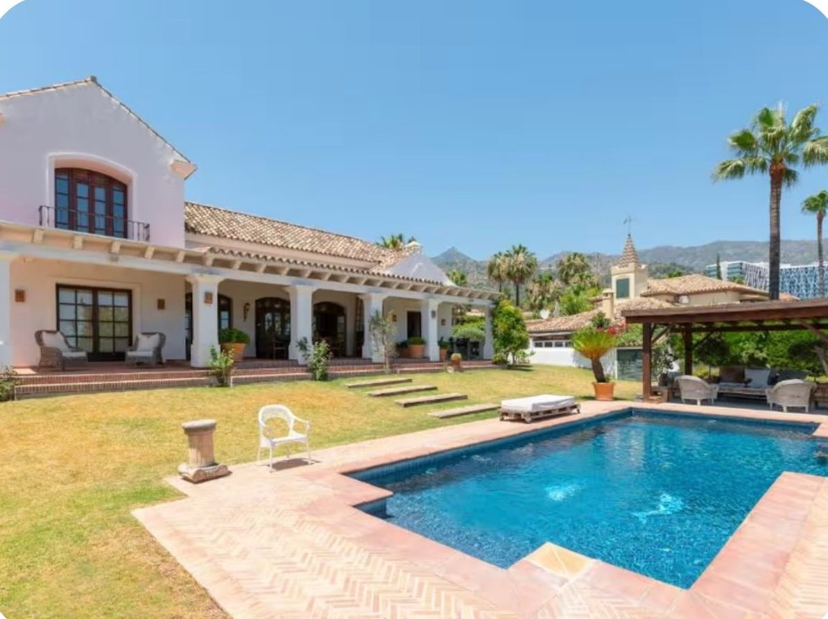 Private villa with a large pool, lawn and covered terrace in the Marbella hills